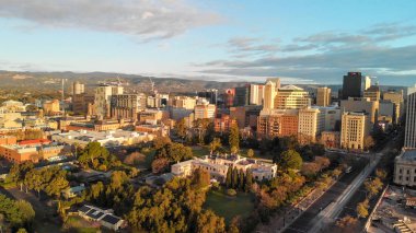 ADELAIDE, AUSTRALIA - SEPTEMBER 16, 2018: Aerial view of city skyline at sunset. Adelaide is the main city of South Australia State. clipart