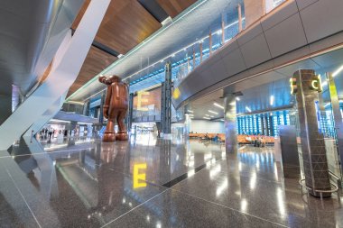 DOHA, QATAR - AUGUST 16, 2018: Interior of Hamad International Airport. The airport opened on April 30, 2014 with a ceremonial Qatar Airways flight. clipart