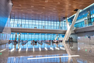 DOHA, QATAR - AUGUST 16, 2018: Interior of Hamad International Airport. The airport opened on April 30, 2014 with a ceremonial Qatar Airways flight. clipart