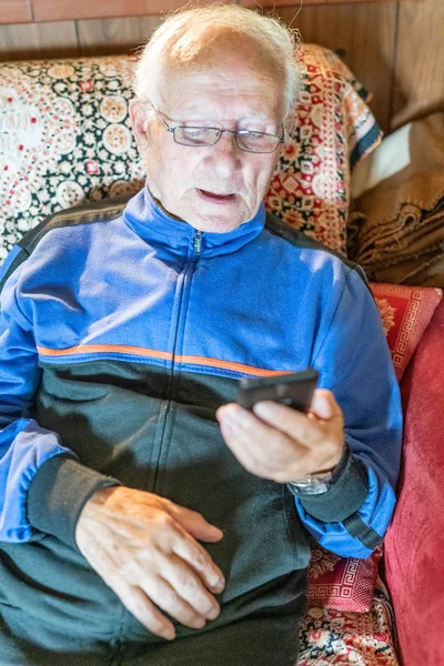Elderly Man Glasses Looking Mobile Phone Home — Stock Photo, Image