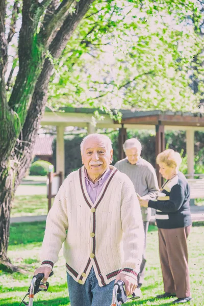 Oudere Man Met Wandelaar Wandelen Tuin Van Het Ziekenhuis Terwijl — Stockfoto