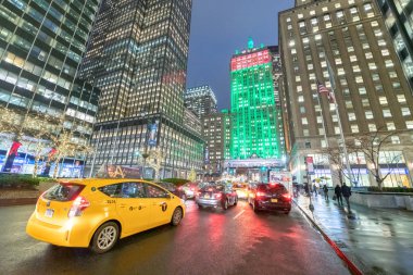 NEW YORK CITY - NOVEMBER 30, 2018: Night view of trafffic in Park Avenue. The city attracts 50 million people annually. clipart
