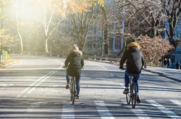 Biking in Central Park during winter season with sun light coming from sky, New York City.