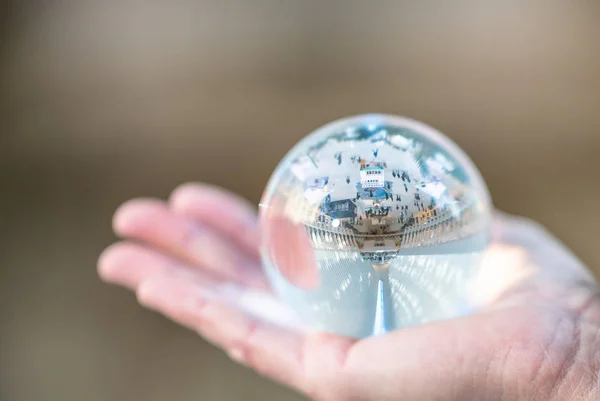 crystal glass ball, held in hand by a woman