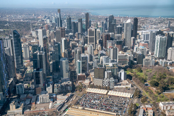 MELBOURNE - SEPTEMBER 8, 2018: Aerial view of city skyline and car parking from helicopter. Melbourne attracts 15 million people annually.