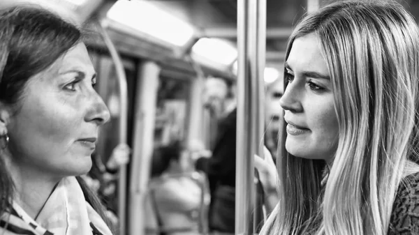 Пара подруг разговаривают в поезде метро — стоковое фото