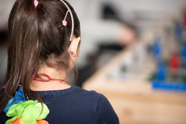 Back view of young girl watching table football — Stock Photo, Image