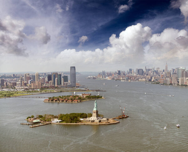 Helicopter view of Statue of Liberty with Lower Manhattan and Jersey City in the background, New York City.