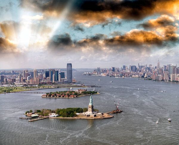 Helicopter view of Statue of Liberty with Lower Manhattan and Jersey City in the background, New York City.