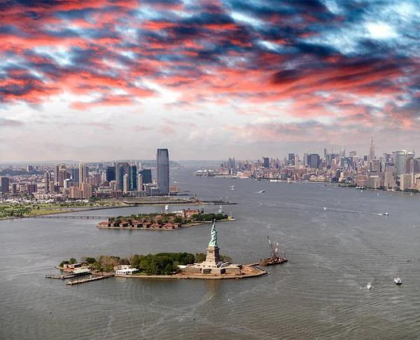 Helicopter view of Statue of Liberty with Lower Manhattan and Je