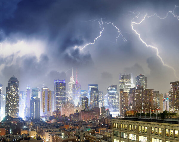 Aerial view of Midtown Manhattan skyline with storm in the background.