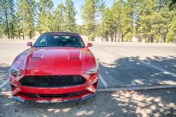Red  sport car in a national park parking — Stock Photo, Image