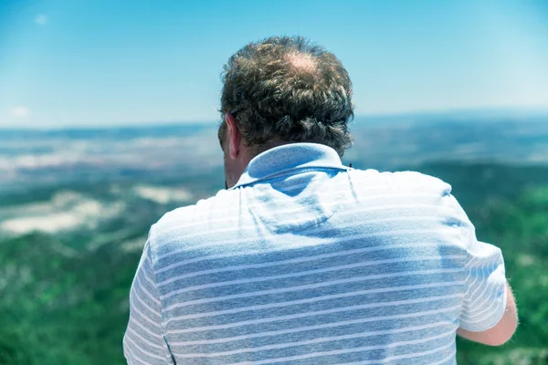 Back view of photographer taking shot of national park