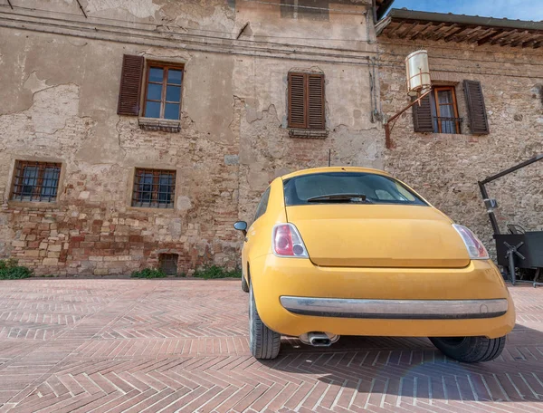 Coche amarillo aparcado en una antigua ciudad medieval italiana —  Fotos de Stock