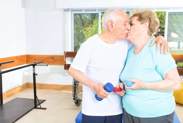 Pareja Mayor Besándose Gimnasio Con Pesas Las Manos Felicidad Fitness —  Fotos de Stock