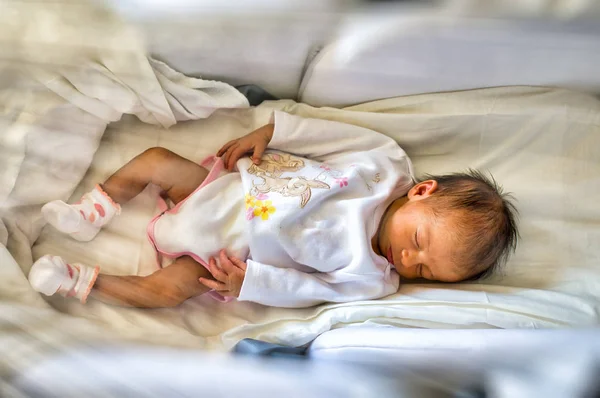 Newborn baby girl in the cradle — Stock Photo, Image