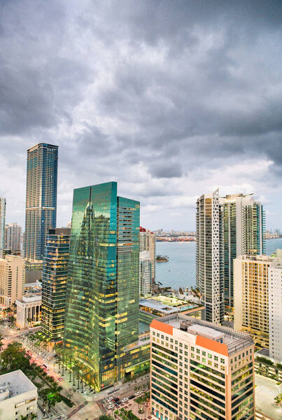 Amazing night skyline of Downtown MIami. Wide angle portrait view of city skyscrapers on a cloudy morning.