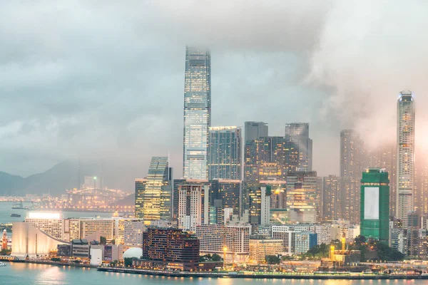 V Kowloonu mrakodrapů. Noční Panorama s odrazy vody — Stock fotografie