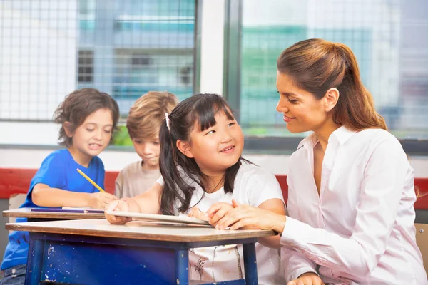 女子教員との授業中の多民族小学校 — ストック写真