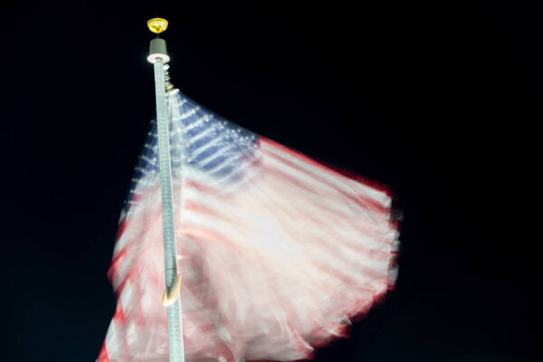 Long exposure of american flag waving at night