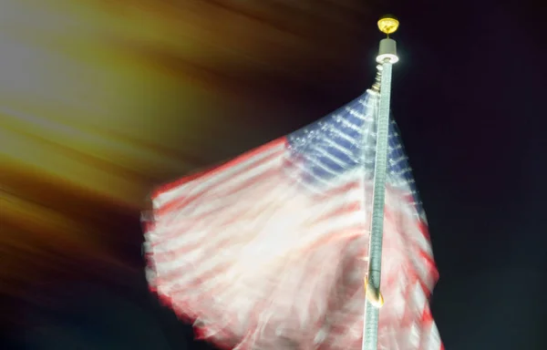 Long exposure of american flag waving at night — Stock Photo, Image