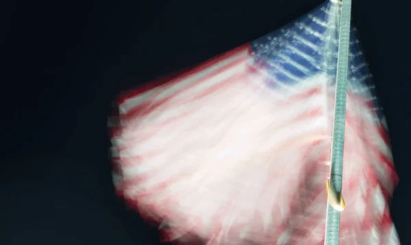 Long exposure of american flag waving at night — Stock Photo, Image