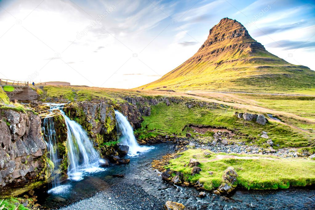 Kirkjufell Waterfalls and Mountain at sunset, wide angle view on