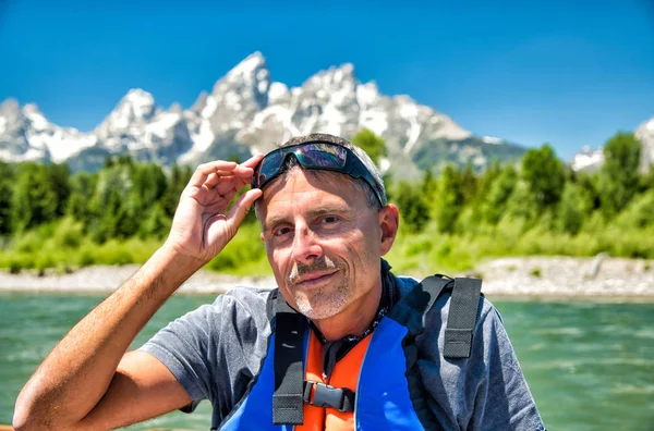 Happy man touching his sunglasses during a boat excursion trip — Stock Photo, Image