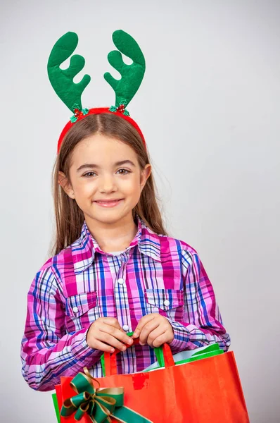 Young girl with Christmas gifts isolated on white background — Stock Photo, Image