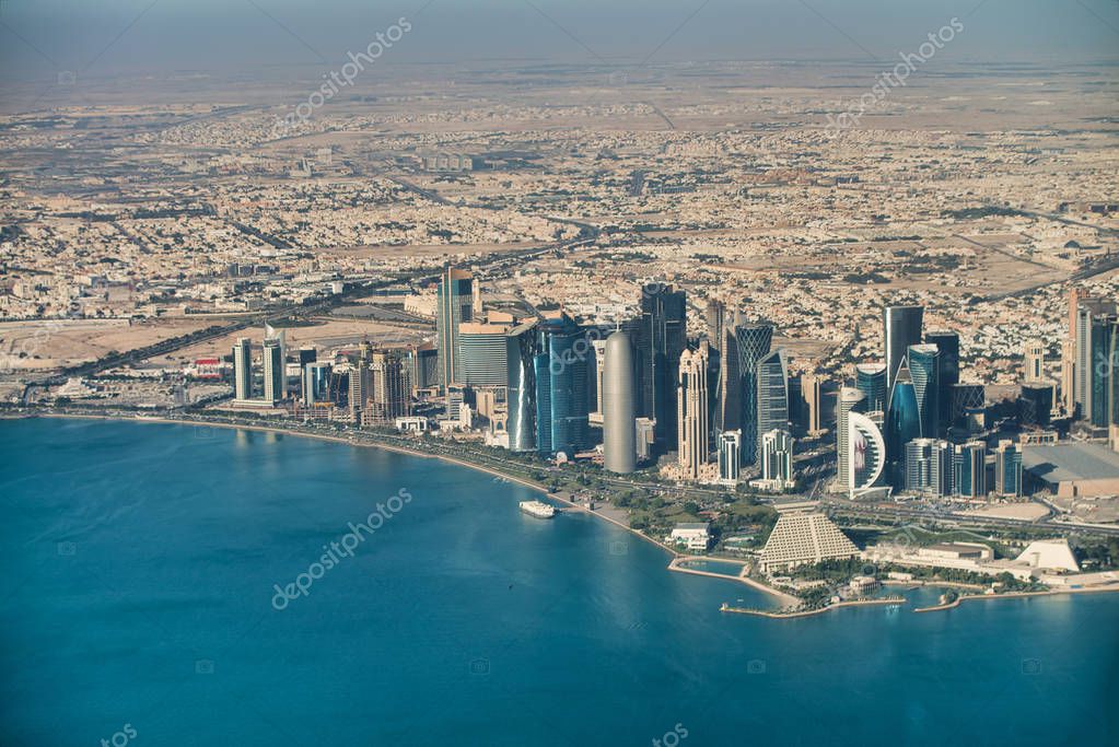 Doha, Qatar. Aerial view of beautiful modern skyline from a moving aricraft.