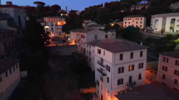 Massa Marittima, Tuscany. Aerial view at night of medieval town. Slow motion — Stock Video