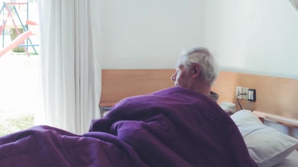 Медленное движение пенсионера, встающего утром — стоковое видео