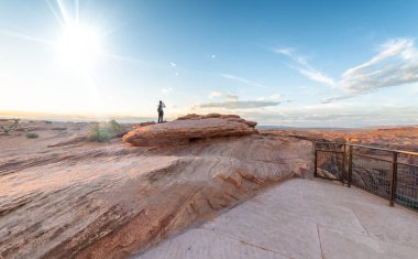 Horseshoe Bend, Page, AZ 'de gün batımını izleyen kadın..