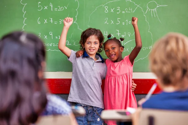 Happy African Girl Caucasian Boy Embracing Smiling Classroom Chalkboard Back — Stock Photo, Image