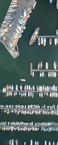 Overhead aerial view of small boats docked in the port, panoramic drone viewpoint.