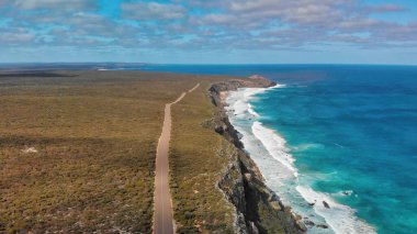 Flinders Chase National Park in Kangaroo Island. Amazing aerial view of road and coastline from drone on a sunny day. clipart