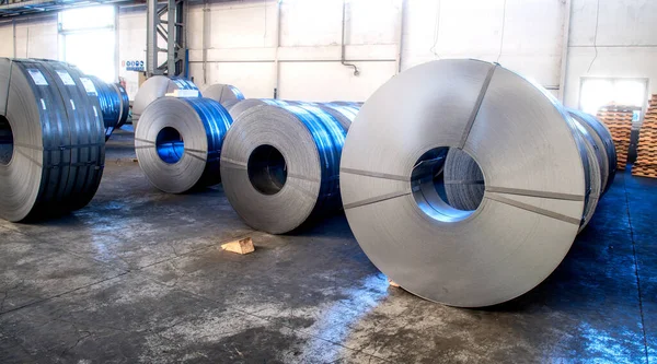 Warehouse of metal coils. Industrial production and logistics concept. Roll of steel sheet in a plant.