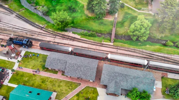 Aerial view of train station in the countryside.