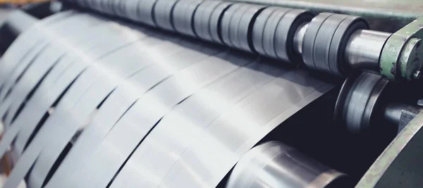 Rolled steel. Stack of rolls, cold rolled steel coils in action. Galvanized steel sheet and rusted edge. Cold rolled steel coils. Drum turns sheets into production. Industrial
