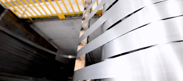 Rolled steel. Stack of rolls, cold rolled steel coils in action. Galvanized steel sheet and rusted edge. Cold rolled steel coils. Drum turns sheets into production. Industrial