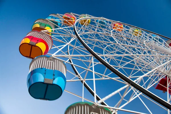 Amazing colors of Luna Park Ferris Wheel at sunset.