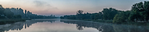 picturesque view of Ros river surrounded by endless green forest at sunrise, Bila Tserkva city, Ukraine   