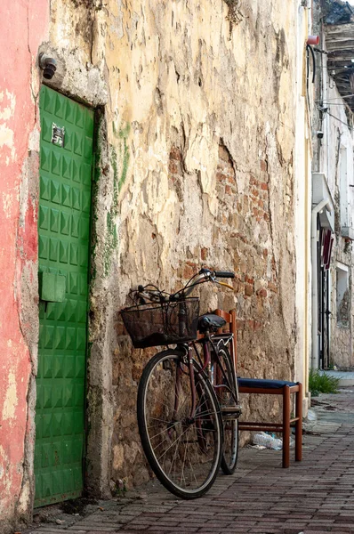bicycle near old building wall at street