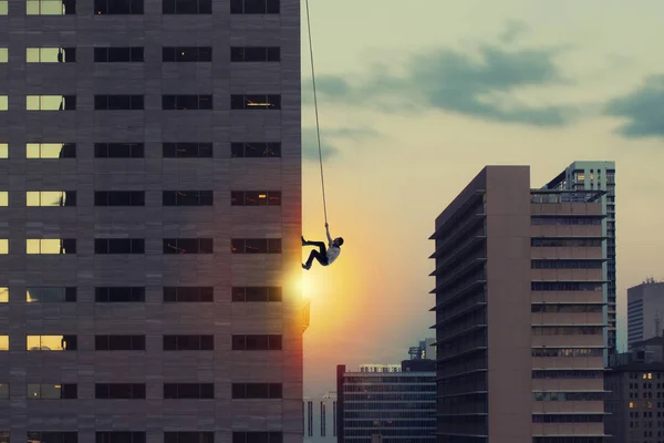 Un uomo d'affari sale su un grattacielo. Conseguimento dell'obiettivo aziendale e difficile concetto di carriera — Foto Stock