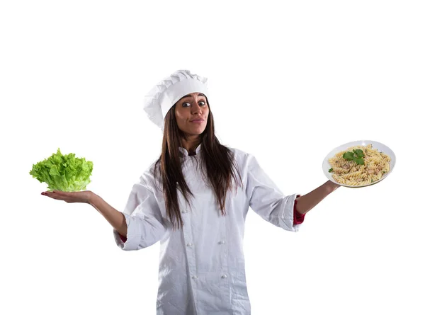 Chef undecided between fresh salad or pasta dish — Stock Photo, Image