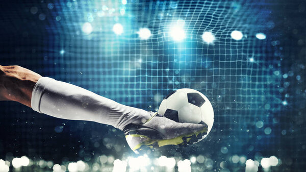 Close up of a soccer striker ready to kicks the ball in the football goal