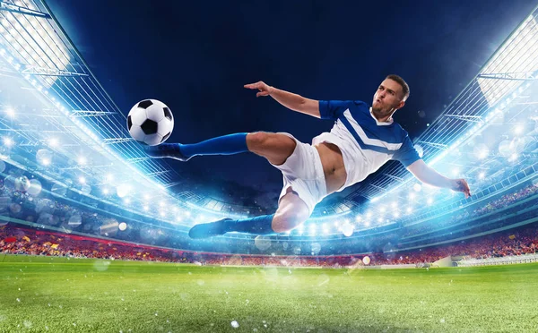 Soccer striker hits the ball with an acrobatic kick in a stadium — Stock Photo, Image