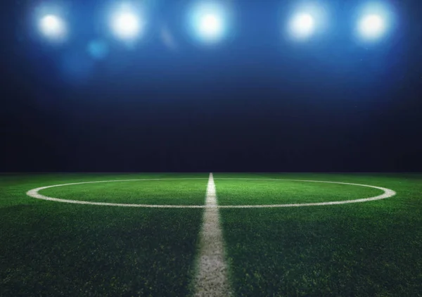 Midfield of grass soccer field at night with headlights — Stock Photo, Image