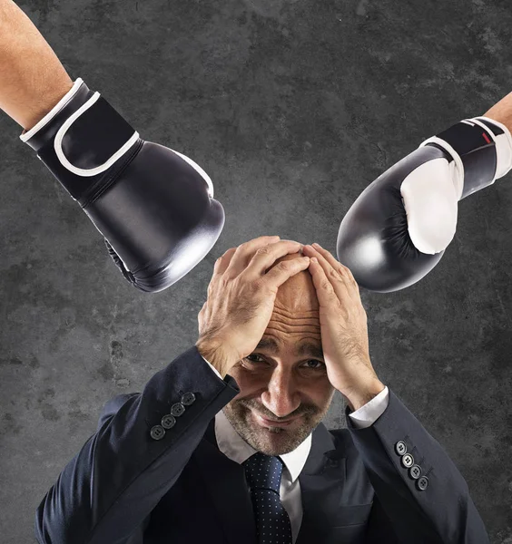 Businessman receives fists from competitors. concept of difficult career — Stock Photo, Image