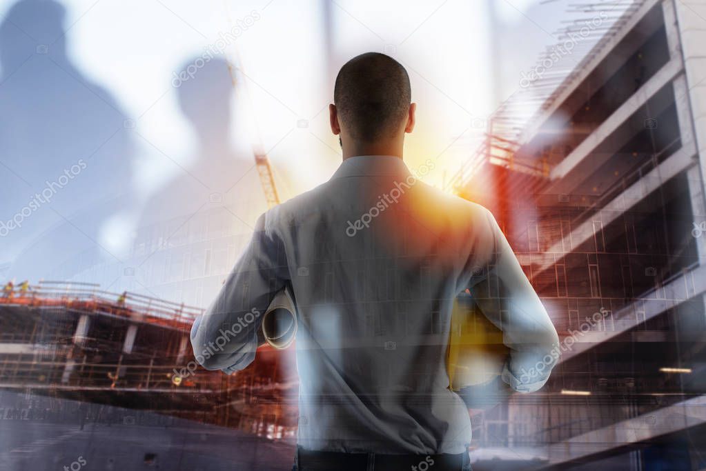 Businessman Architect analyzes the works of a building. double exposure